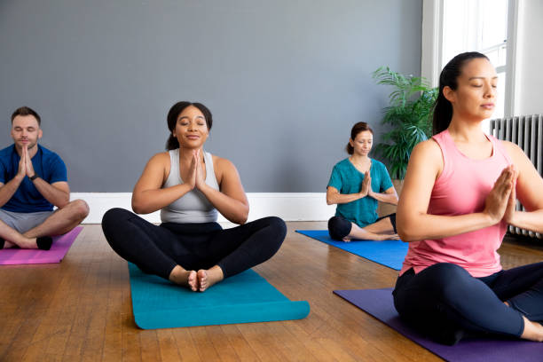 istock Diverse Group of Active People doing Yoga together 1350050723