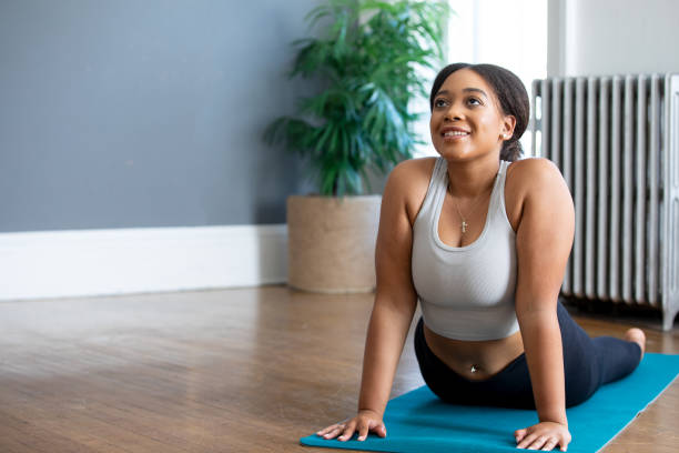 istock Young Woman doing Yoga by herself on mat 1350050733