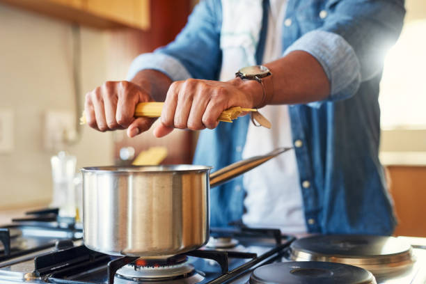 istock Shot of a man breaking spaghetti before boiling it 1350051809