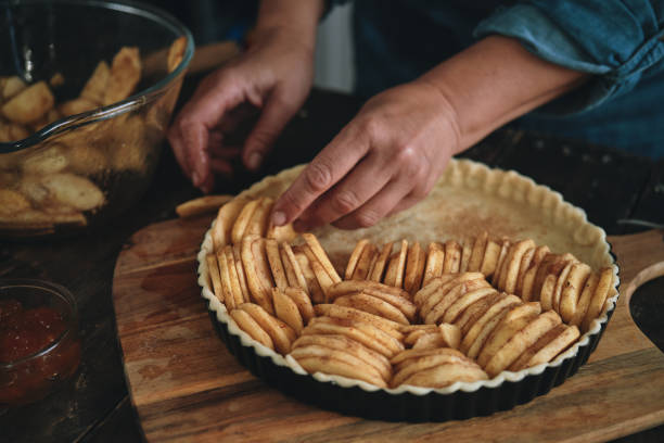 Preparing Apple Pie in Domestic Kitchen Preparing Apple Pie in Domestic Kitchen APPLE PIE stock pictures, royalty-free photos & images