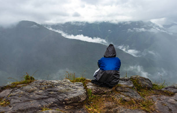 istock young man hiker at the mountain top with dramatic sky at morning from flat angle 1350052137