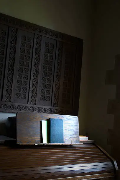 Book on church organ sunlit by windowlight