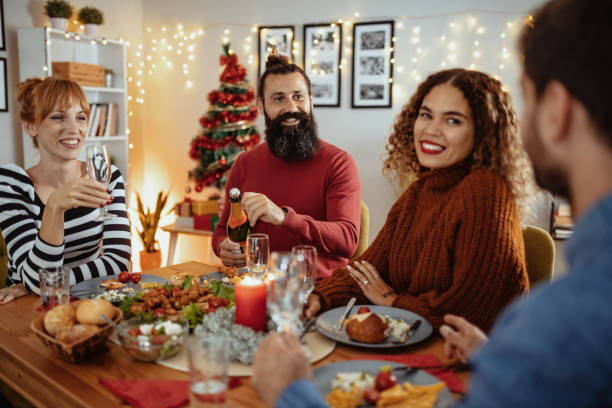 istock Couples eating Christmas dinner and laughing 1350061366
