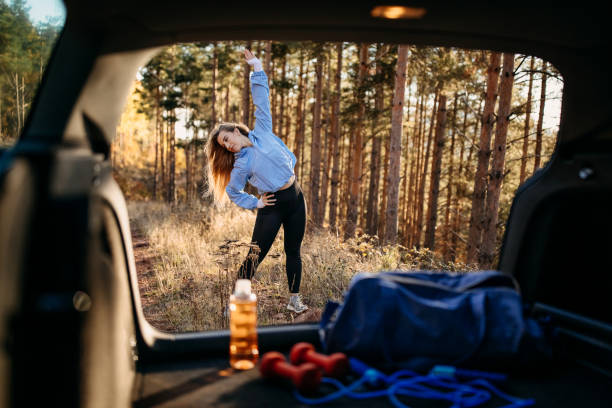 I have to be ready Young woman preparing for running in forest Stretching on the Go: Simple Exercises to Do in Your Car for Back Pain Relief stock pictures, royalty-free photos & images I have to be ready Young woman preparing for running in forest Stretching on the Go: Simple Exercises to Do in Your Car for Back Pain Relief stock pictures, royalty-free photos & images