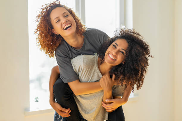 istock Happy girlfriends in a tender moment at home 1350062636