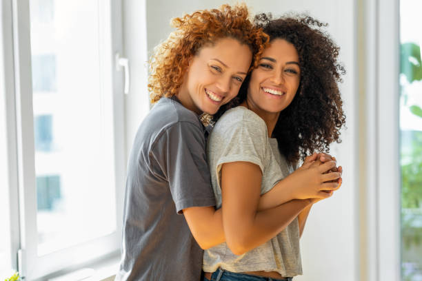 istock Happy girlfriends in a tender moment at home 1350062713