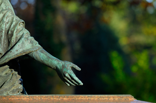 Hand of an old Jesus Chris statue in a cemetery in Germany