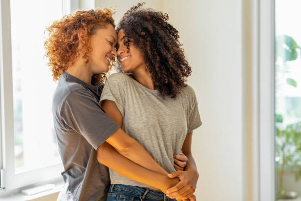 Happy girlfriends in a tender moment at home Happy girlfriends in a tender moment at home lesbian stock pictures, royalty-free photos & images