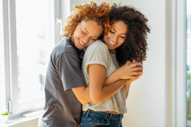 istock Happy girlfriends in a tender moment at home 1350062880