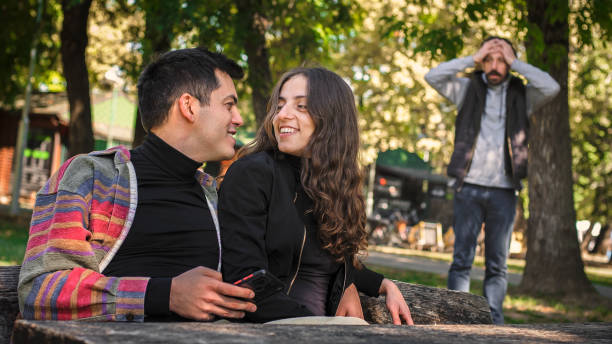istock Adultery and infidelity. Girlfriend cheating his jealous boyfriend. Relationship polygamy 1350063024
