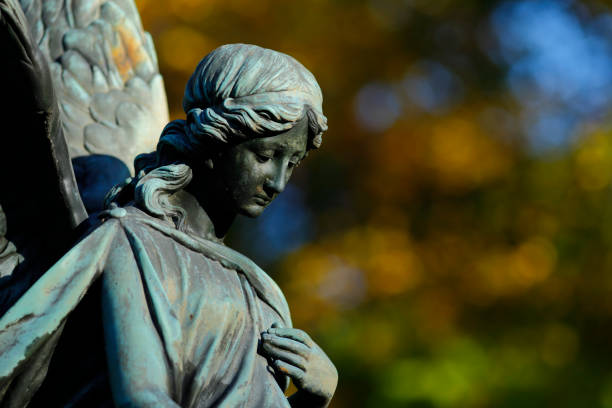 istock Antique Angel statue in a Cemetery 1350063042