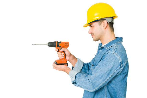 istock Profile of a handyman using a driller 1350063264