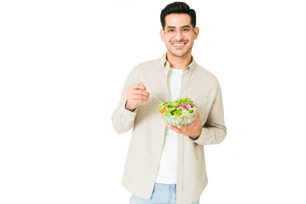 istock Cheerful man enjoying a fresh salad 1350063978