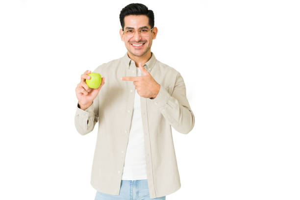 istock Happy young man eating his greens 1350064091