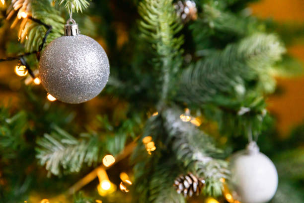 istock Classic Christmas decorated New year tree. Christmas tree with wite and silver decorations, ornaments toy and ball. Modern classical style interior design apartment. Christmas eve at home 1350065412
