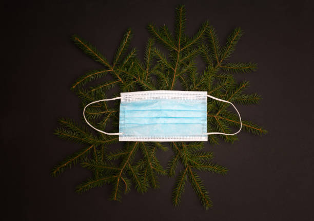 istock Christmas tree with a face mask as a holiday ornament. 1350065432