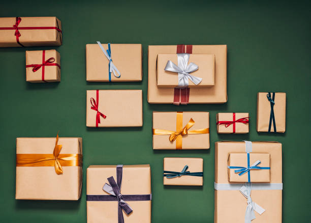 istock Lots of Gift Boxes on the Green Background Beautifully Wrapped 1350065491