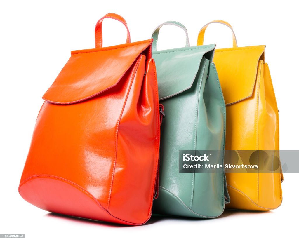 Three leather backpacks for girls and women salmon, mint, yellow Purse Stock Photo