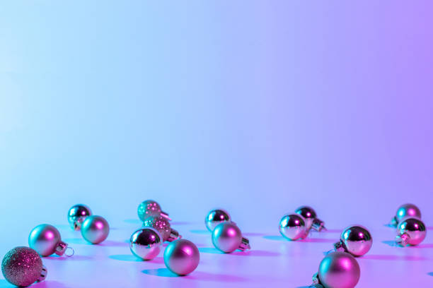 istock Christmas balls pattern neon background. Xmas bauble on abstract holiday winter gradient backdrop. Happy new year copy space. 1350070195