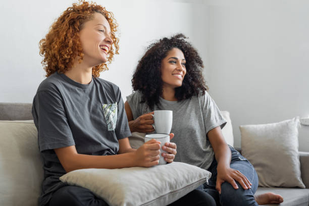 istock Girlfriends are watching their favorite tv show while sitting on the couch 1350071431