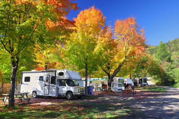 Colorful Camping Site at Fall RV and Camping Trailers in Camping Site at Fall fall picnic table stock pictures, royalty-free photos & images