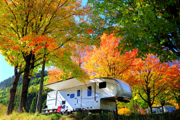 istock Large Camping Trailer under Colorful Autumn Trees 1350073437