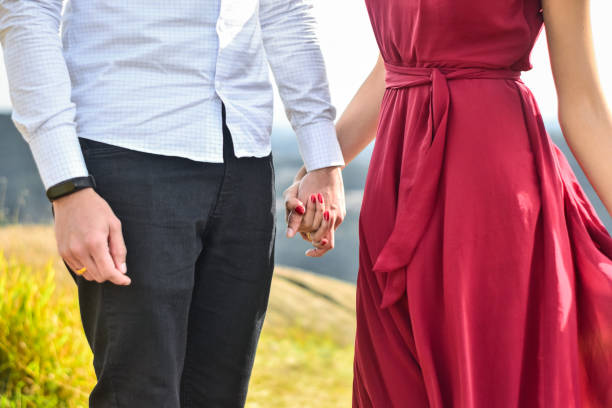 istock Hands of a couple standing on a mountain 1350073889