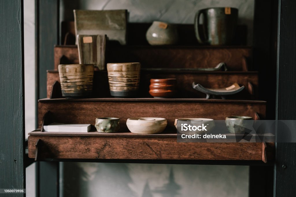 Pottery jugs and cups made of natural clay. Pottery master's workshop. concept is a manual hobby. Pottery jugs and cups made of natural clay. Pottery master's workshop. concept is hobby. Adventure Stock Photo