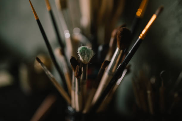 istock Accessories and items on the shelf in pottery workshop: brushes, glasses, jugs. workshop of master of pottery. concept - clay modeling 1350074641