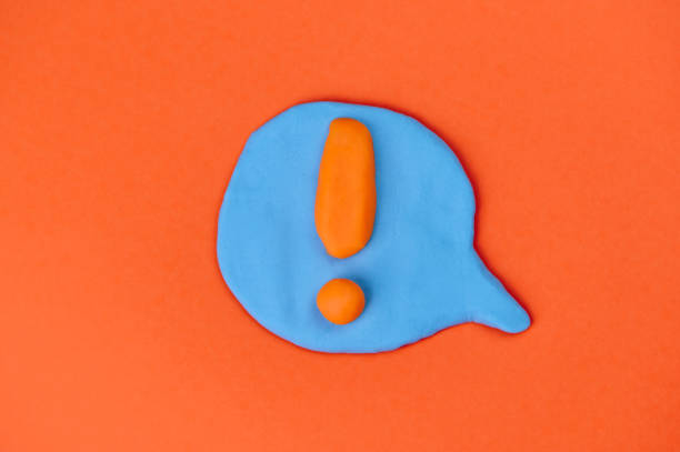speech bubble with orange exclamation mark in the center stock photo