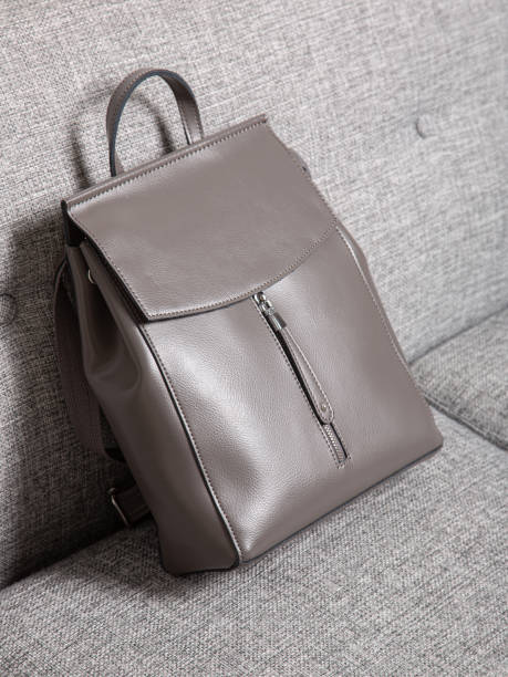 istock Grey bag backpack with straps with zippers. A bag for things, accessories and textbooks is in the interior of apartment. 1350077903