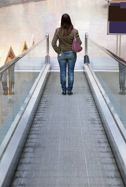 istock Woman on moving walkway 135007814