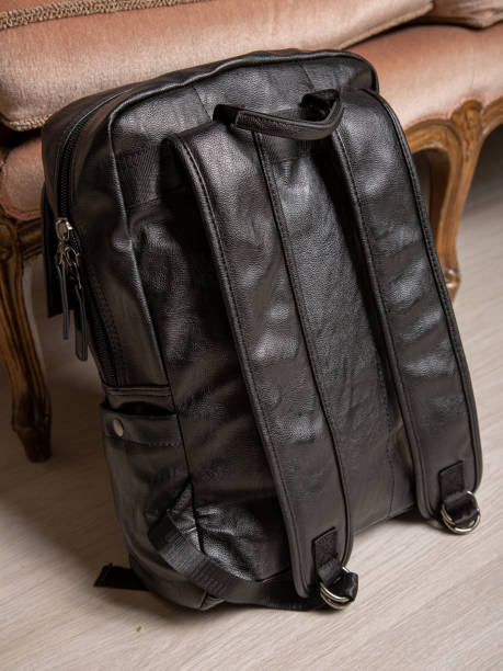 istock Black backpack bag with straps with zippers. bag for things, accessories and textbooks is in interior of apartment. 1350079961