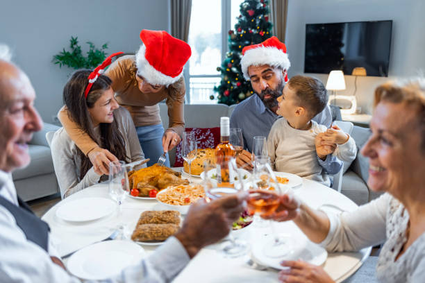 istock Happy family during New Year's dinner at dining table. 1350080179