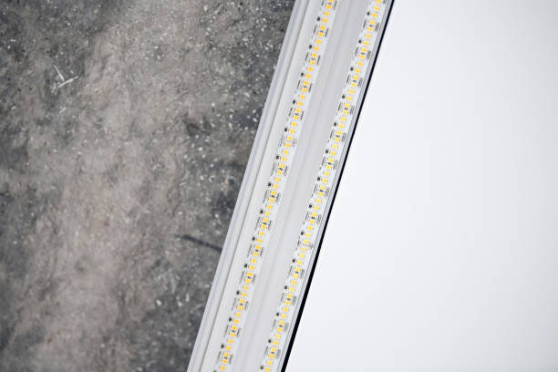 istock Strip LED light with aluminum profile on stretch ceiling, close up. Home renovation concept 1350080265