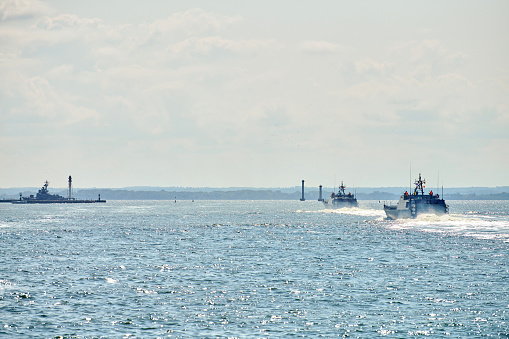 Coastguard, rescue and support patrol boats for defense sailing in blue sea. Navy patrol vessels protecting water borders and fisheries. Military ship, warship, battleship. Baltic Fleet, Russian Navy