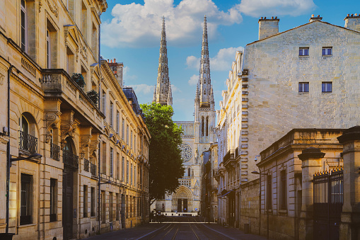 City street scene with tram rails and Saint Andre Cathedral on the back in Bordeaux, France