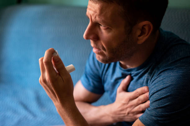 istock Young man treating asthma with inhaler 1350082288