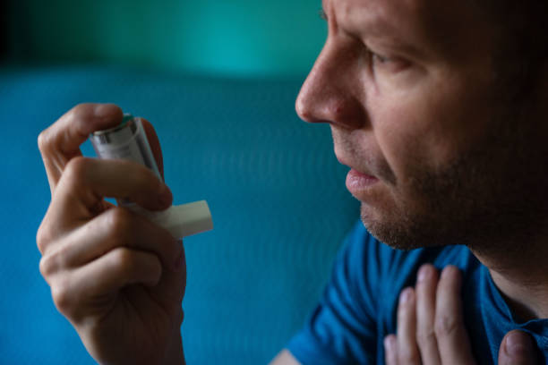 istock Young man treating asthma with inhaler 1350082293