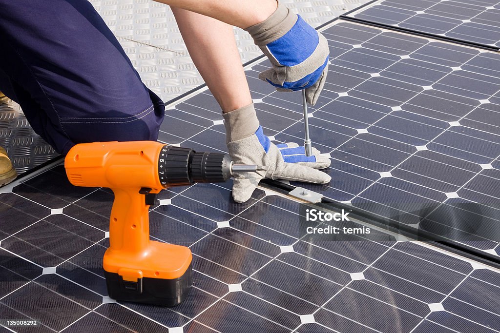 sun energy sun energy with photovoltaic panels, hands at work on it Cable Stock Photo