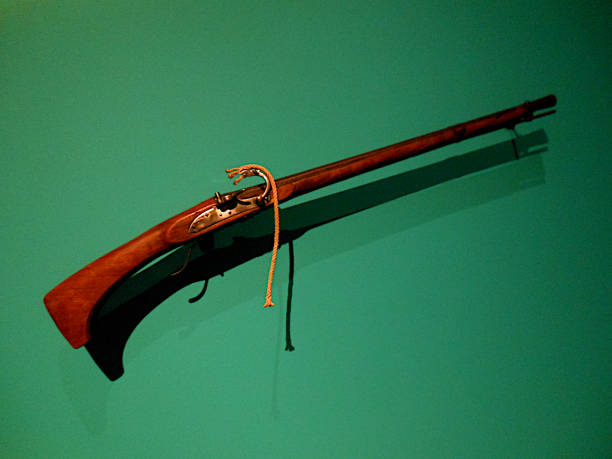 istock Old musket on a green background 1350085361