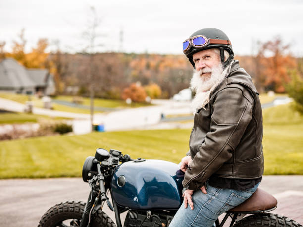 istock Senior man getting ready to ride his motorcycle 1350092415