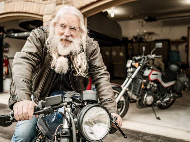 istock Senior man getting ready to ride his motorcycle 1350092553