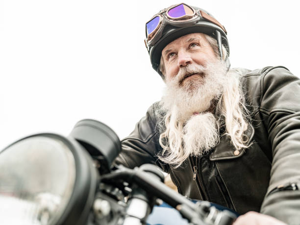 istock Senior man getting ready to ride his motorcycle 1350092634