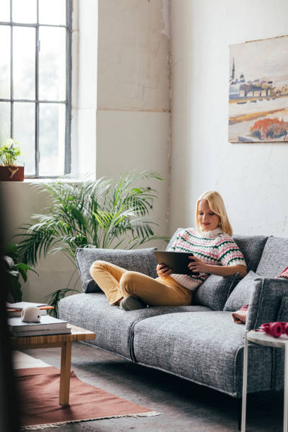 istock Young Woman Using Digital Tablet at Home 1350092722