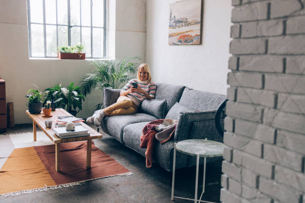 istock Happy Woman Using Mobile Phone at Home 1350092731
