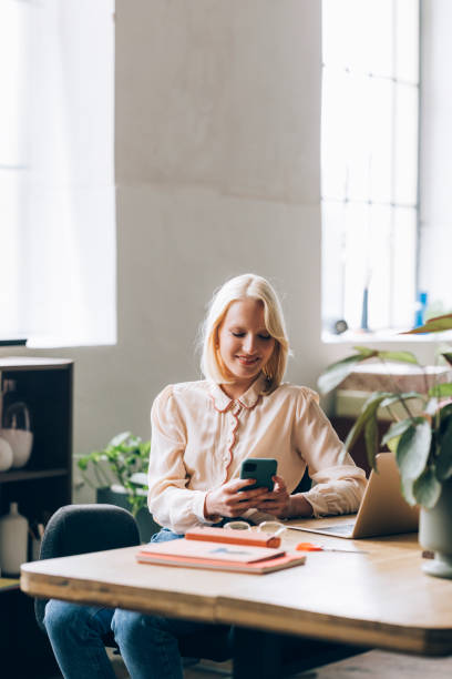 istock Young Business Woman Using Mobile Phone at Home 1350092753