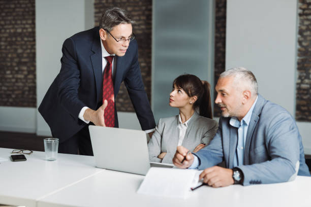 istock Business colleagues communicating while working on a laptop in the office 1350097850