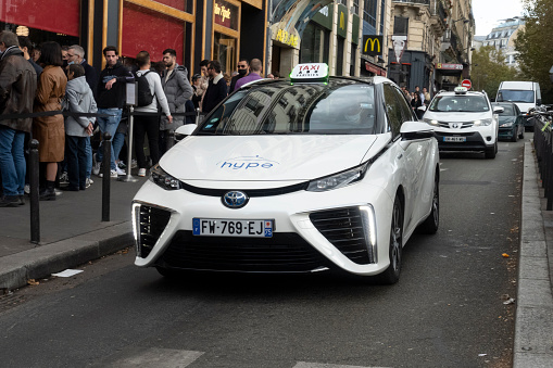 Paris, France - 23 October, 2021: Toyota Mirai hydrogen taxi driving on a street. The batteries of electric motor drives by hydrogen.