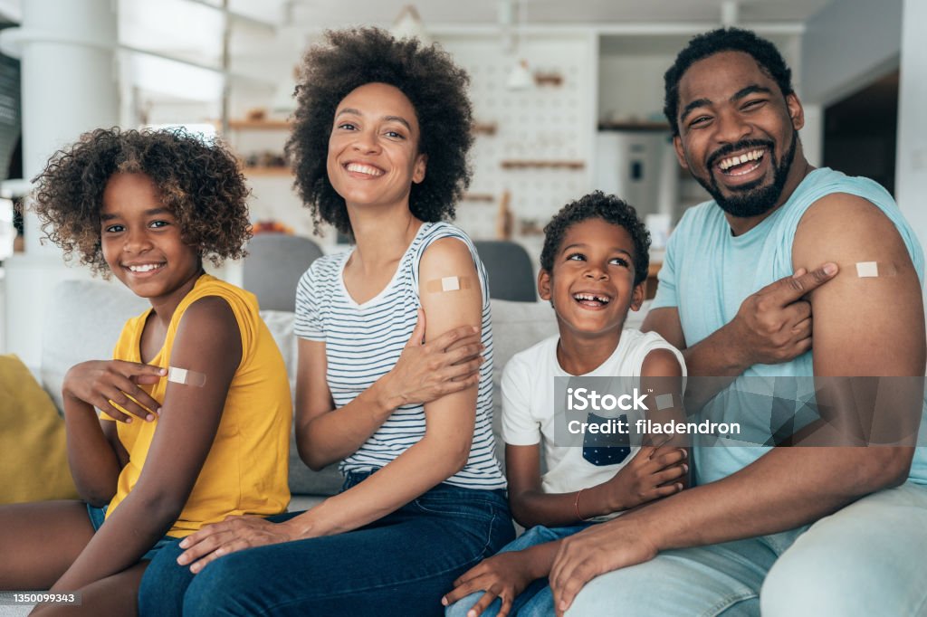 Portrait of a vaccinated family Portrait of family after getting covid-19 vaccine Vaccination Stock Photo